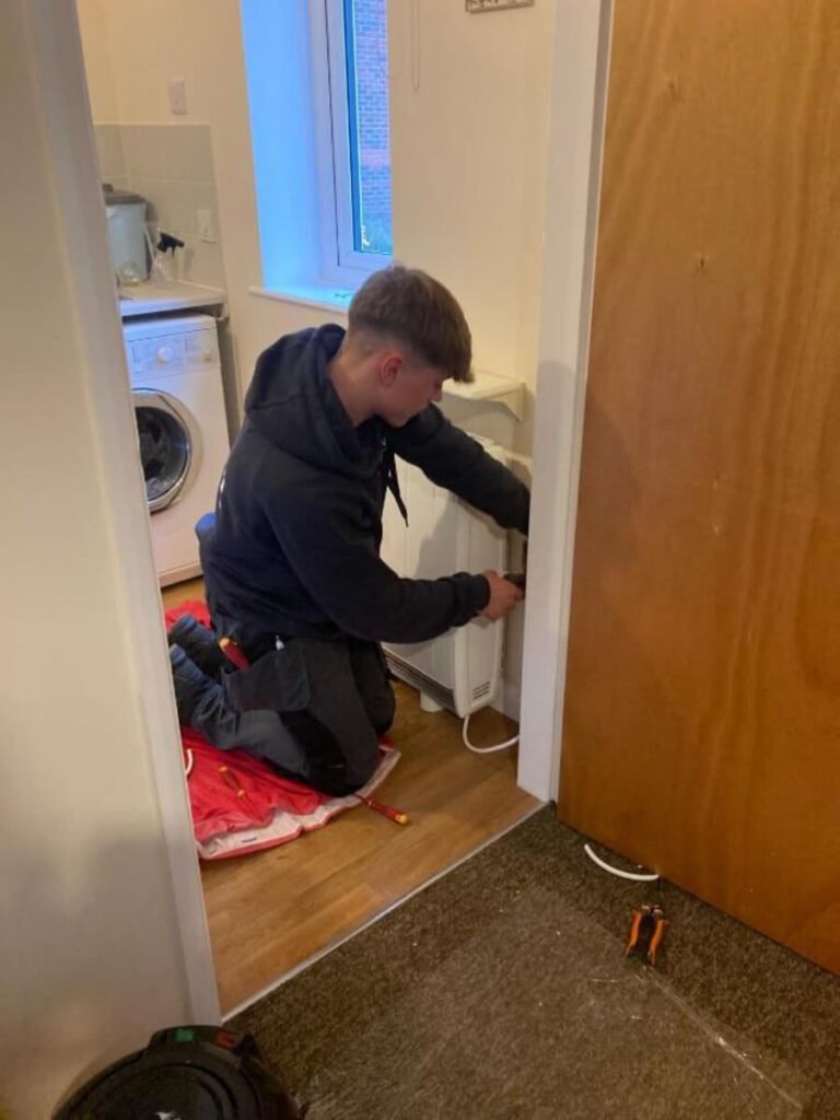 Toby Lloyd-Amos working on electrical installation tasks at Millingtons Hospital